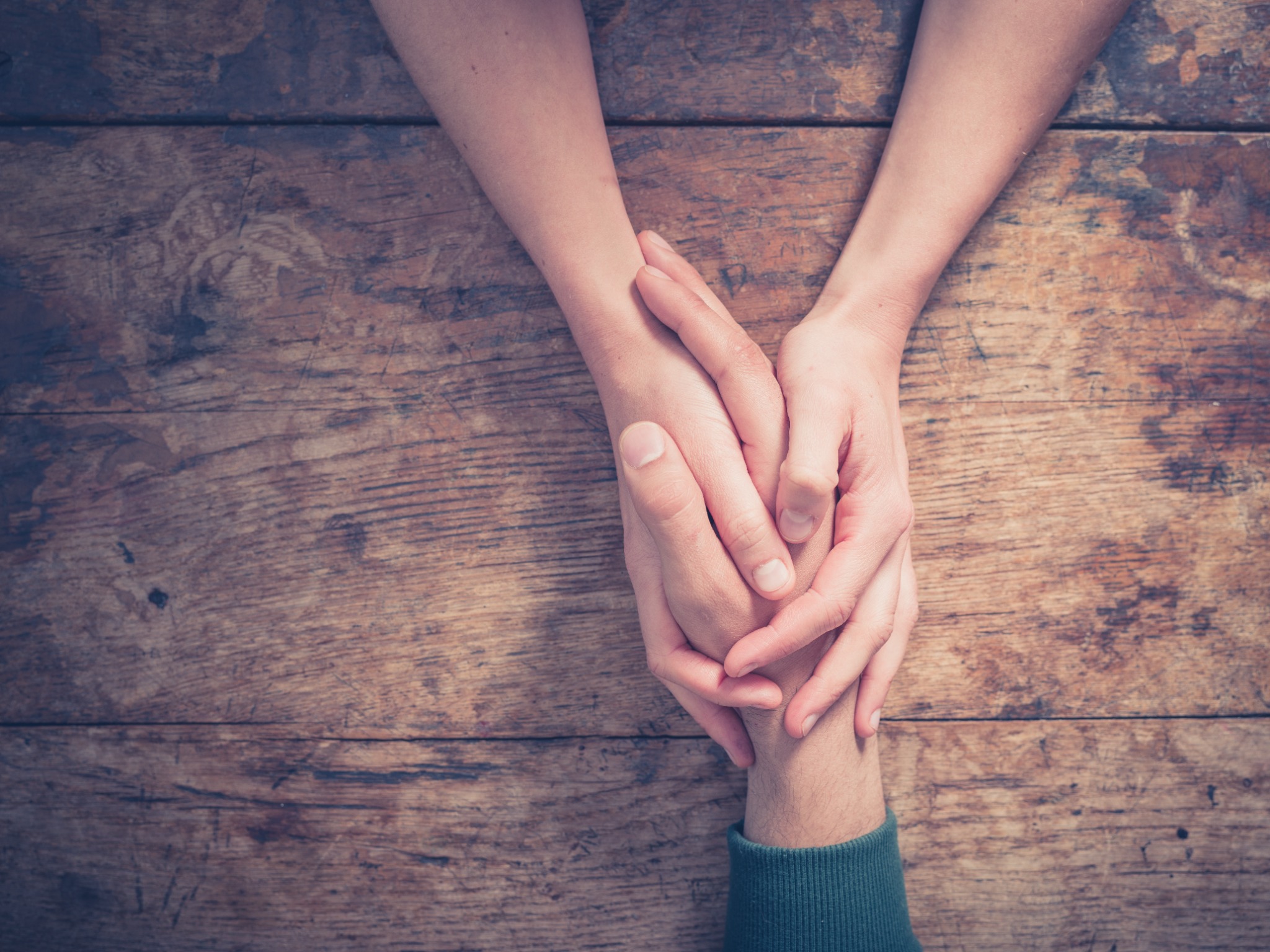 Two people holding hands
